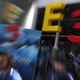 A blurry photograph of E3 2017 shows a giant logo behind convention goers.